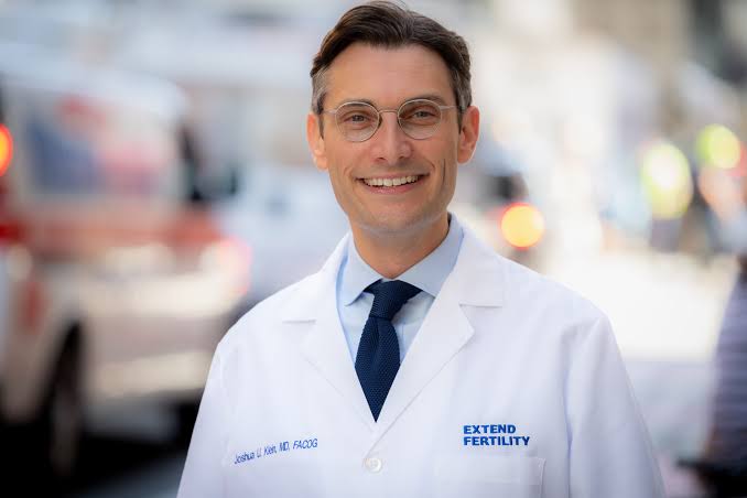 Photo of Dr. Klein in a white lab coat and tie.